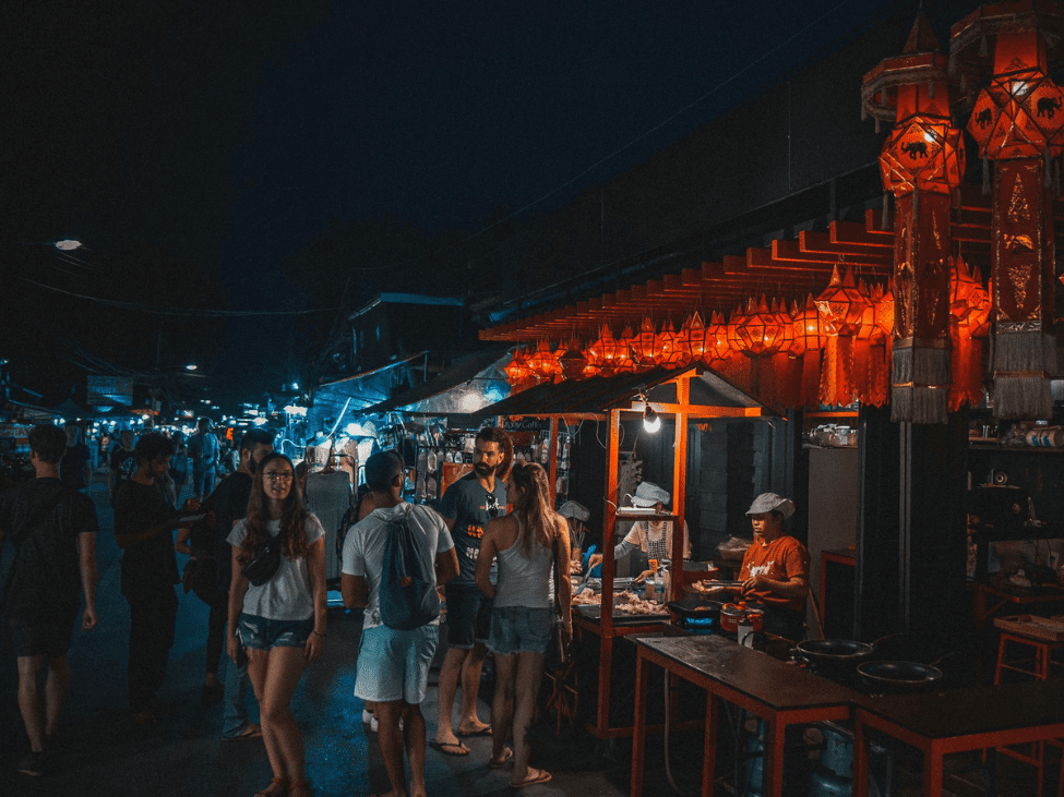The lively Chang Phuak Gate night market with food stalls and bustling activity.