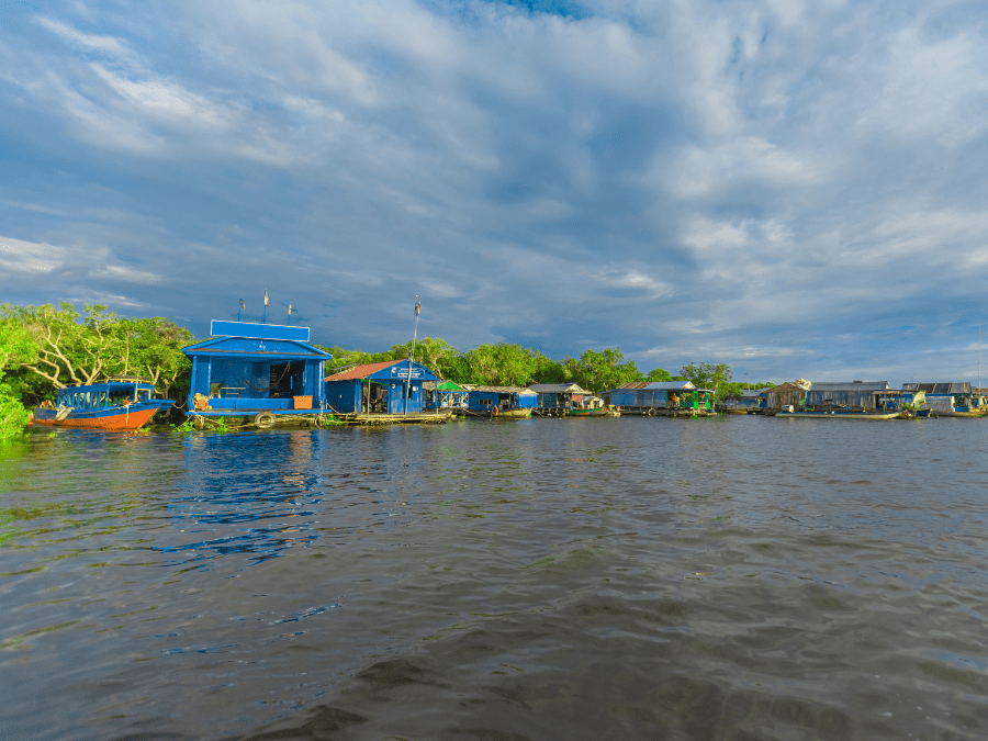Scenic view of Chong Khneas Floating Village with boats and houses on Tonle Sap Lake, Siem Reap.
