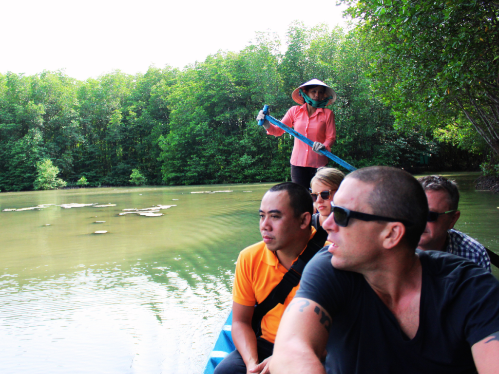 A local guide leading travelers through hidden trails in the Mekong Delta, Vietnam.