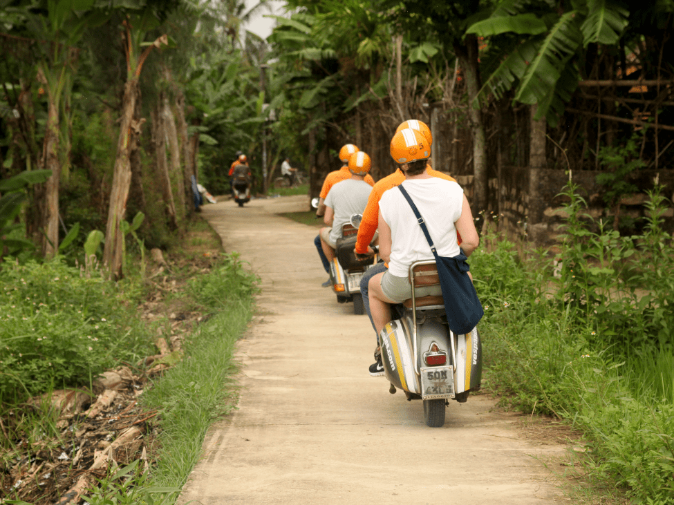 Rural road in Vietnam with varied terrain.