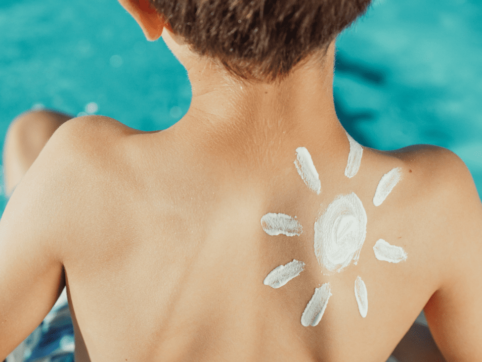 Parent applying sunscreen to a child before a bike ride.