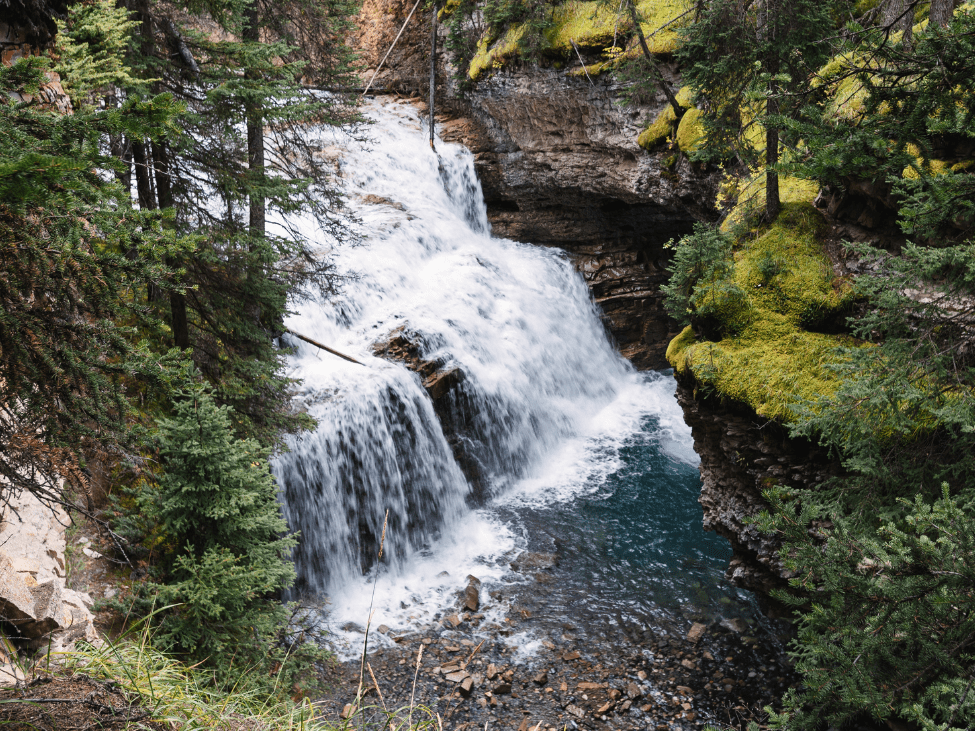 Hikers exploring the Ba Do Phot Waterfall Trail with waterfalls and peaks in the background