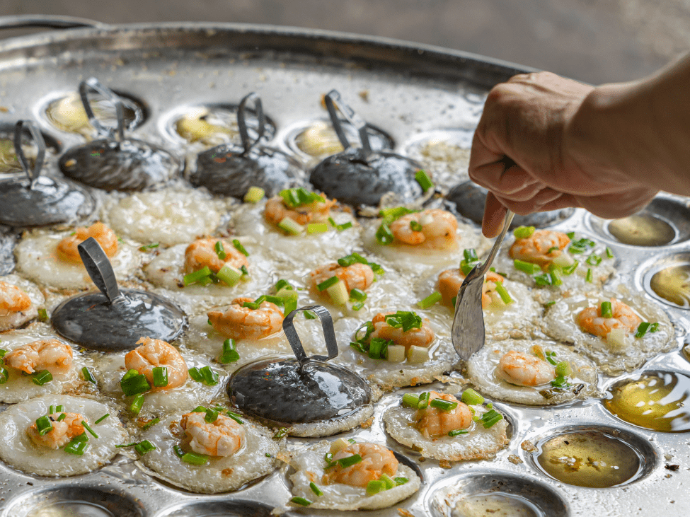 Banh Khot served with fresh herbs and fish sauce in Phu Quoc, Vietnam