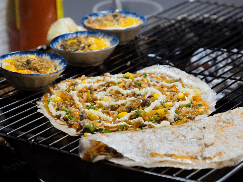 Banh Trang Nuong being cooked at Tay Do Night Market.