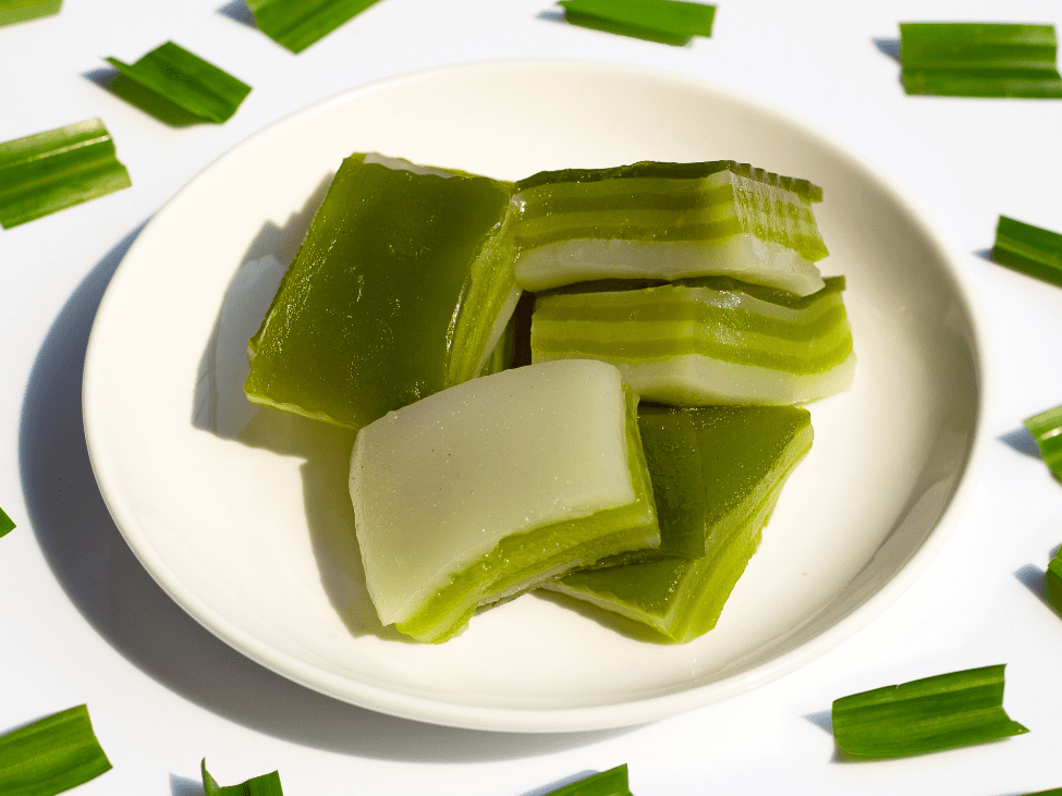 A stack of sliced Bánh Da Lợn showing its green and yellow layers.