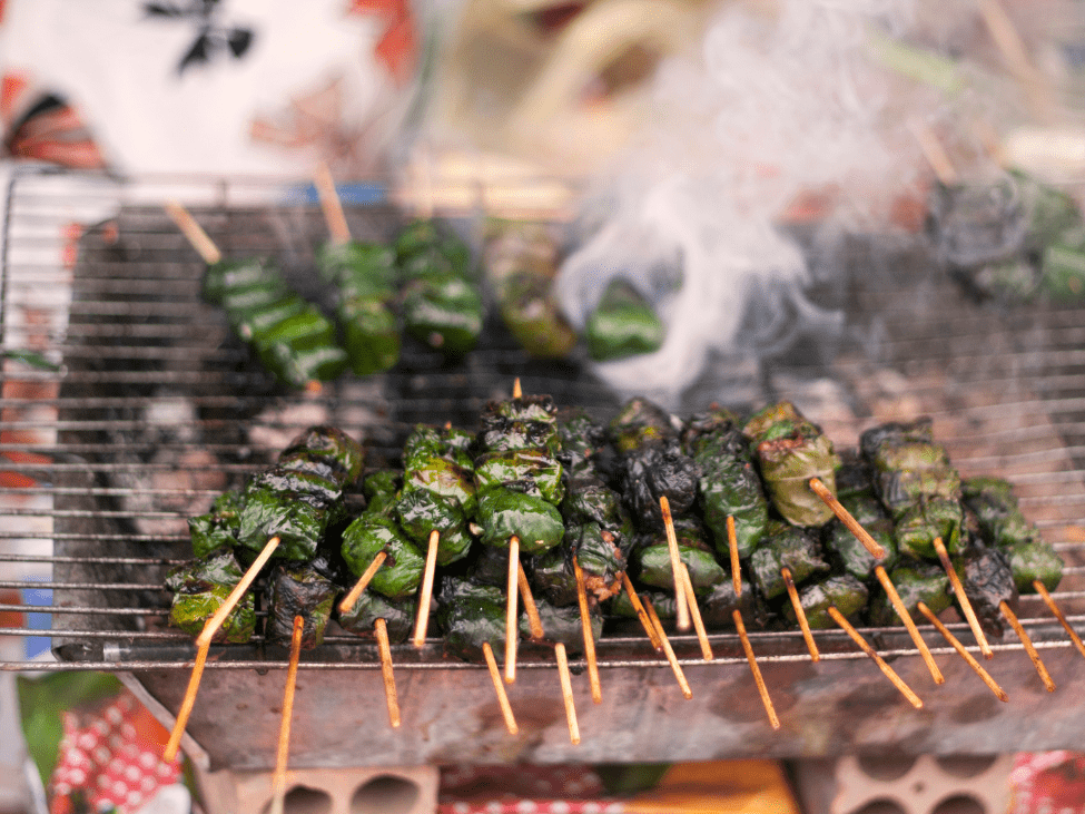 Bo La Lot being grilled at a night market stall.