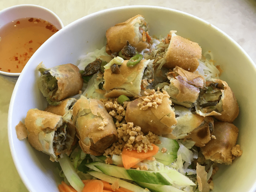 Bowl of vegetarian vermicelli with grilled tofu and fresh vegetables in Vietnam