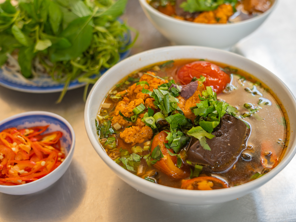 A bowl of Bun Rieu with rice vermicelli and crab paste