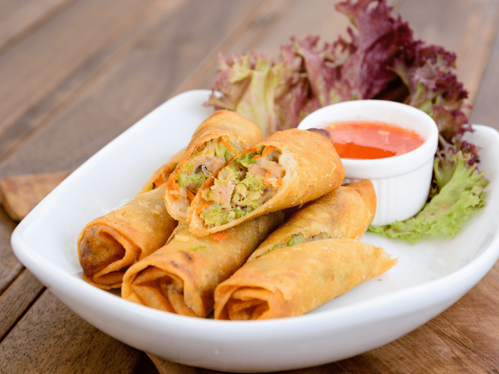 Plate of vegetarian fried spring rolls with dipping sauce in Vietnam