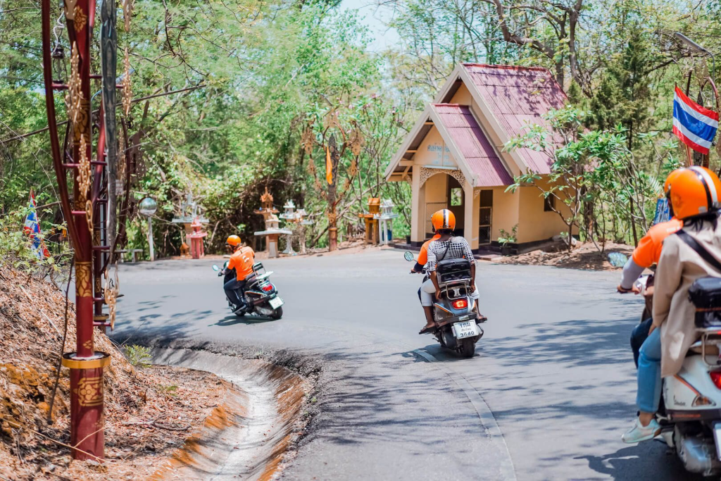 Tourists enjoying the Insider's Chiang Mai tour on Vespas.