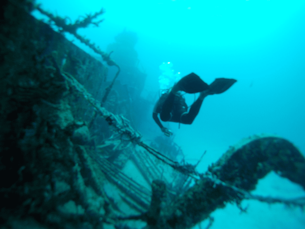 Diver exploring the wreck of the Tai Sin ship in Con Dao, Vietnam