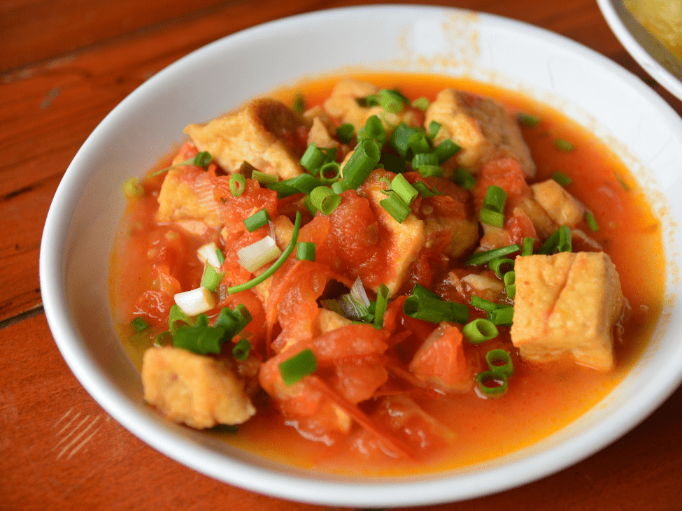 Tofu in tomato sauce served with rice in Vietnam