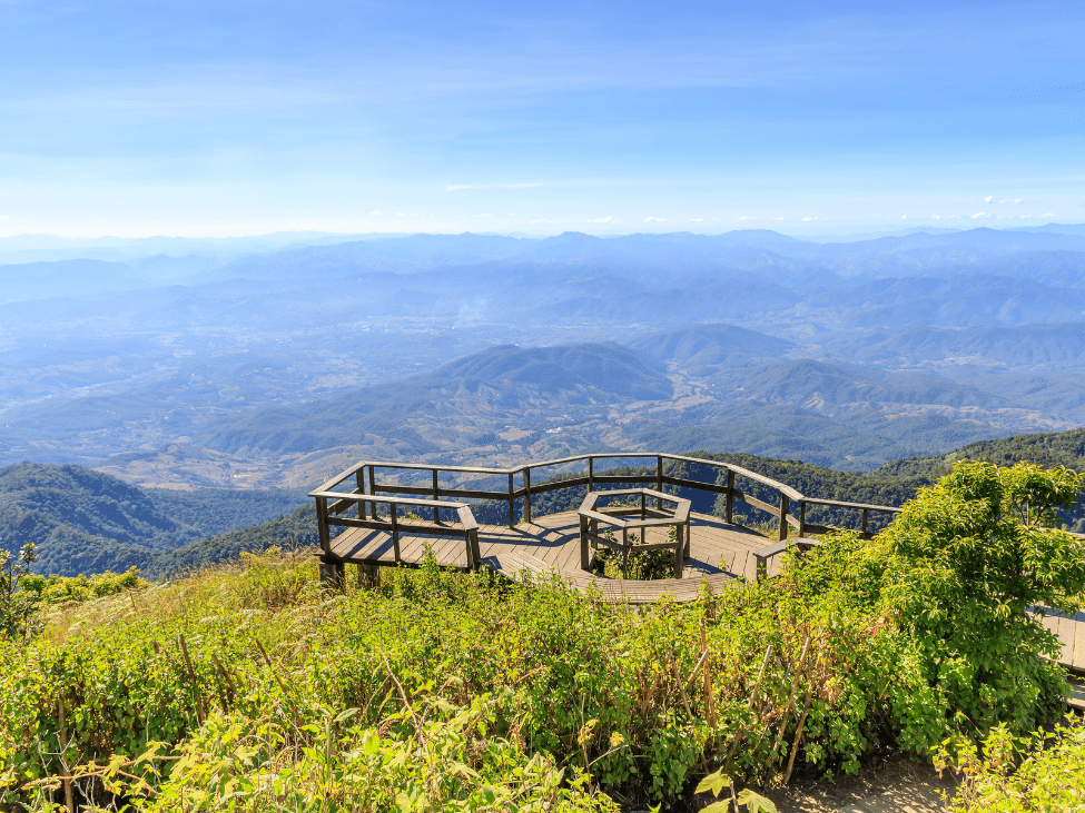 Scenic view of the Kew Mae Pan Nature Trail with lush greenery and distant mountains.