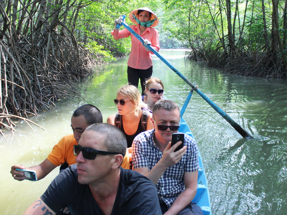 Boat tour through the Mekong Delta's lush landscapes during the monsoon season