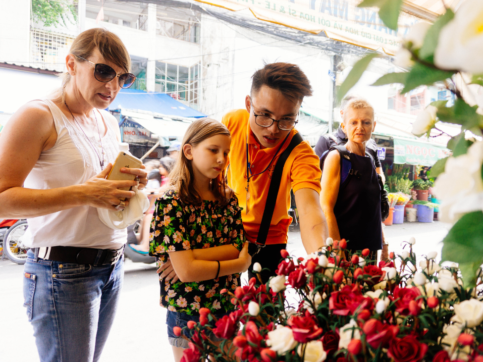 Tourist negotiating prices at a local market in Vietnam