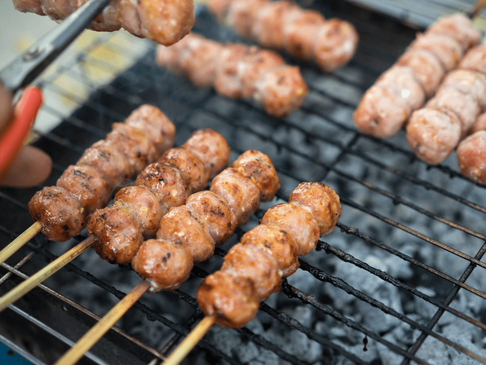 Nem Nuong (grilled pork sausages) served with fresh herbs in Phu Quoc, Vietnam