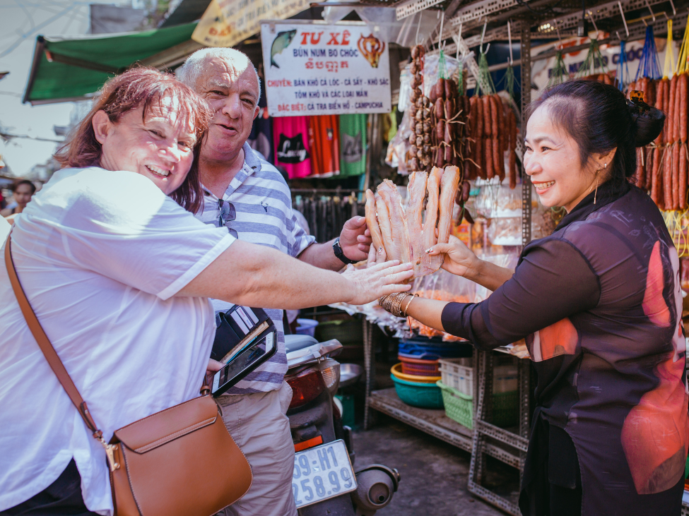 Traveler paying with cash at a street food stall in Vietnam