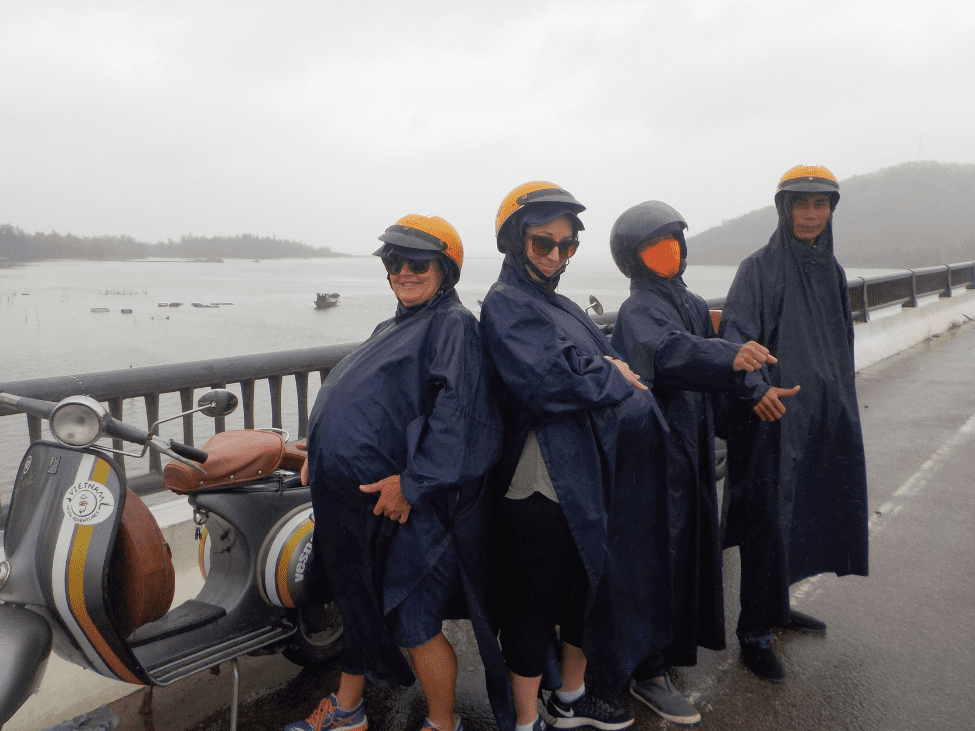 Traveler caught in the rain with an raincoat in Vietnam