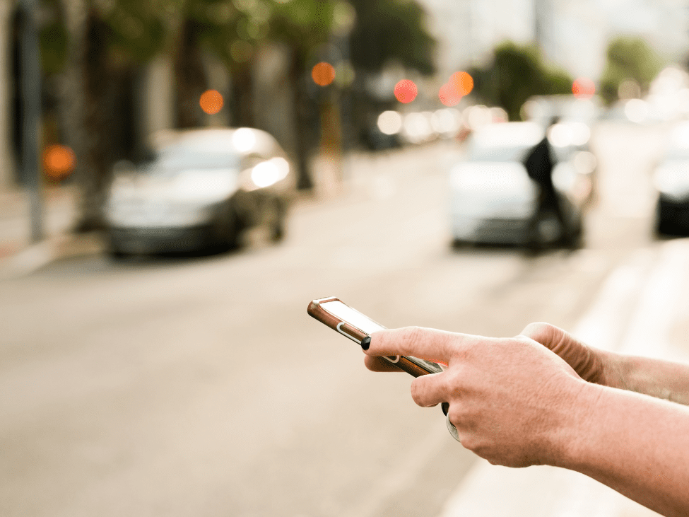 Person using a ride-hailing app on a smartphone.