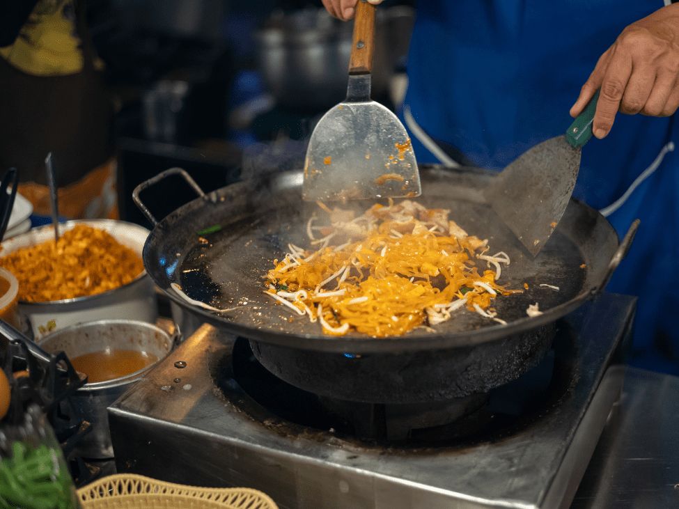 A plate of Pad Thai with lime and peanuts in Thailand