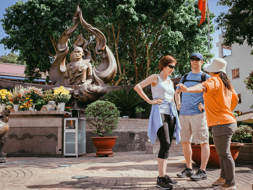 Traveler using a phrasebook to communicate with a local in Vietnam