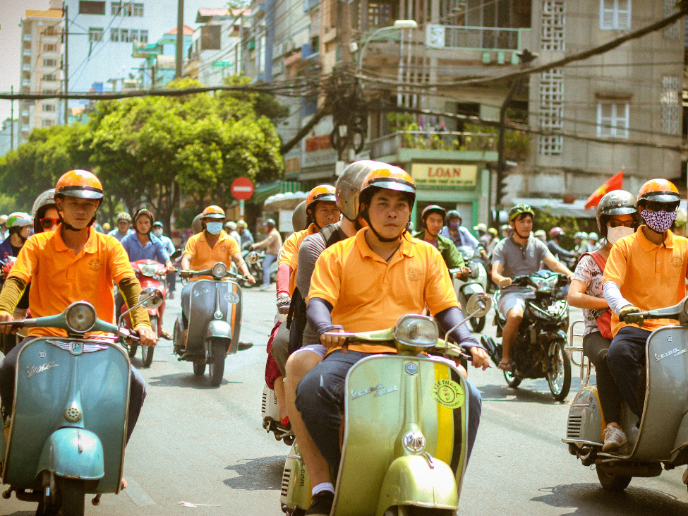 Vespa Adventures tour group exploring Vietnam.