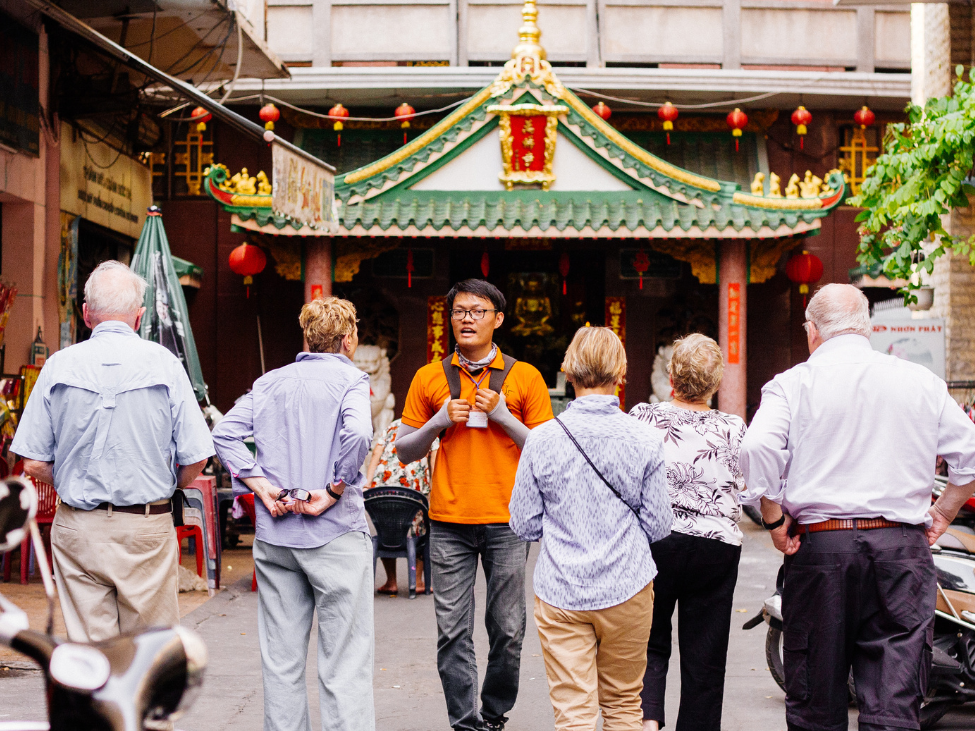 Tourists visiting a temple in Vietnam, dressed modestly