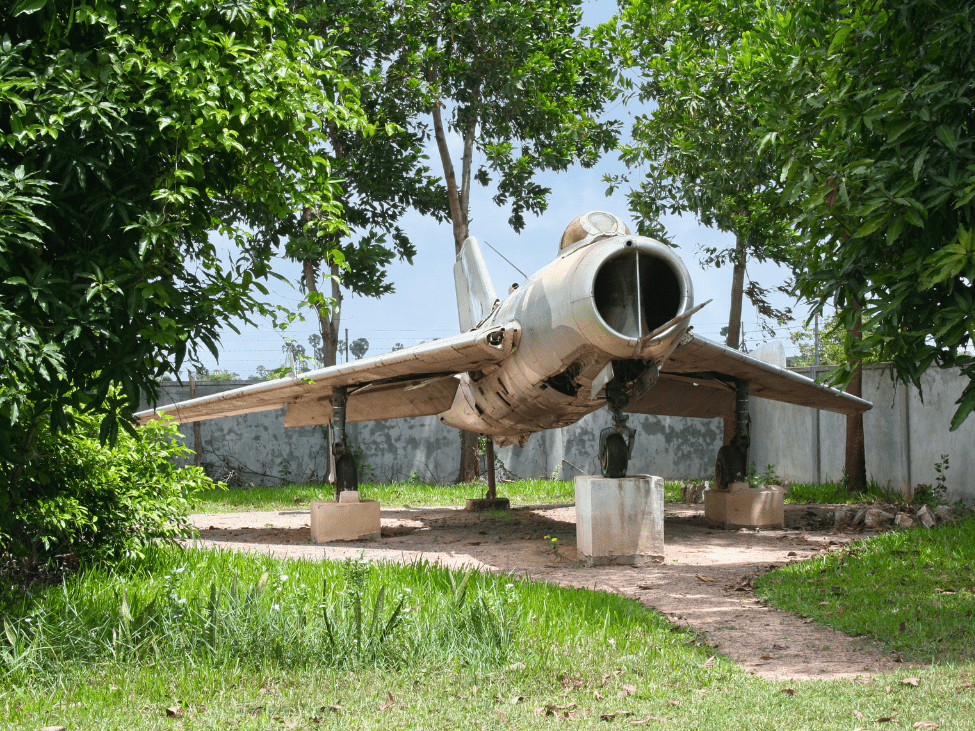 Children exploring old planes and tanks at the War Museum in Siem Reap