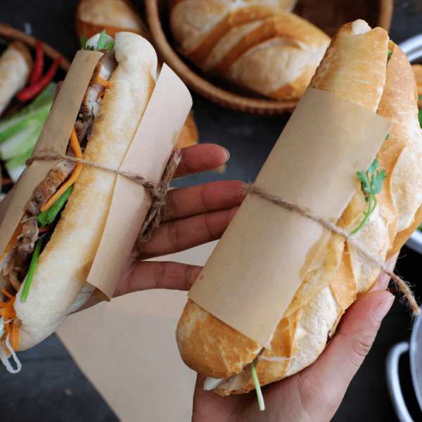 Delicious banh mi sandwich filled with pork, vegetables, and cilantro in Ho Chi Minh City.