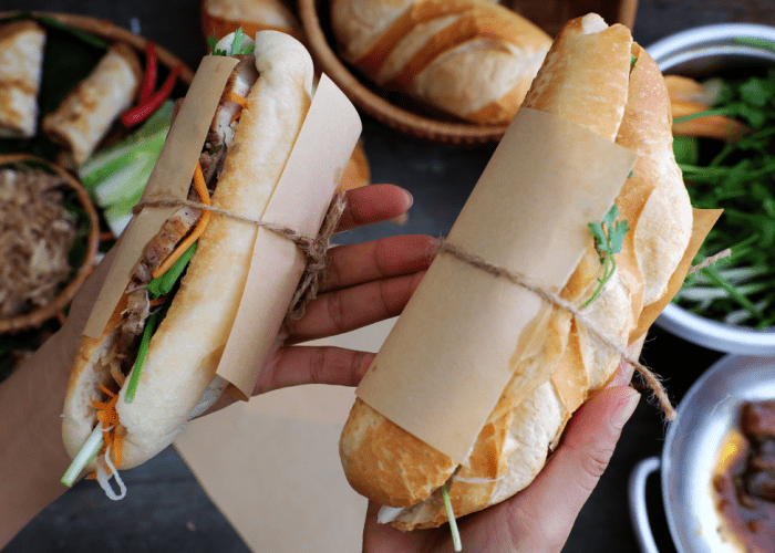 Delicious banh mi sandwich filled with pork, vegetables, and cilantro in Ho Chi Minh City.