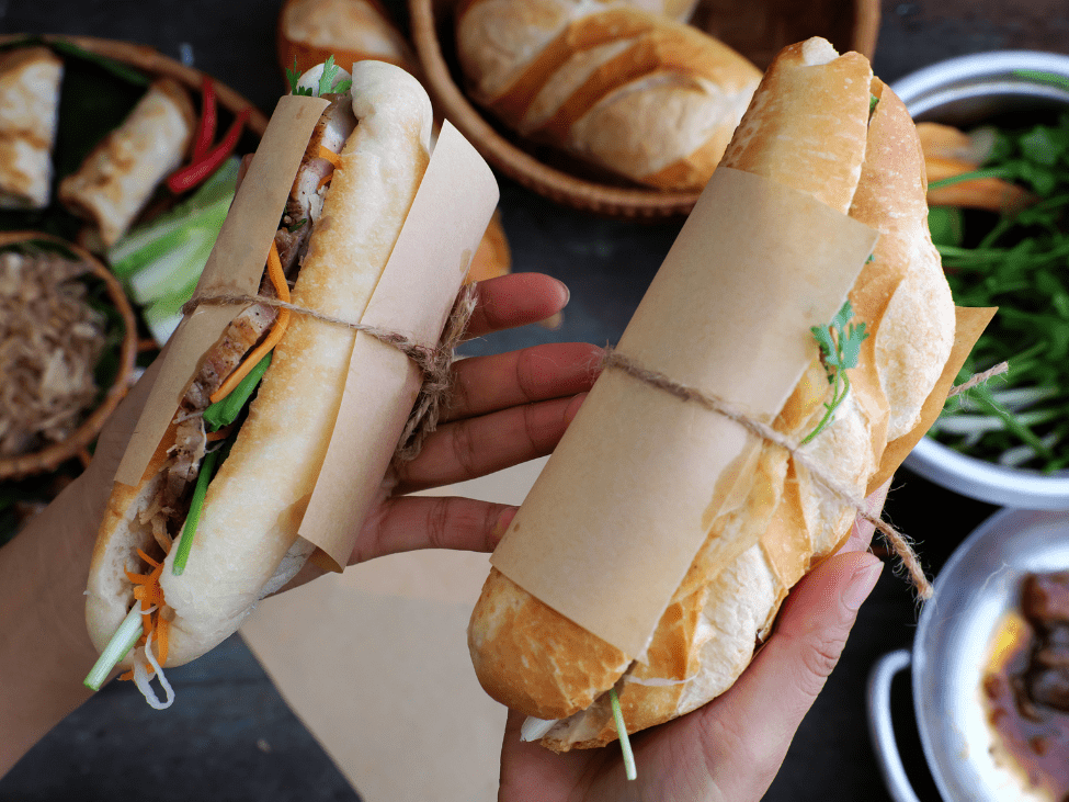 Delicious banh mi sandwich filled with pork, vegetables, and cilantro in Ho Chi Minh City.