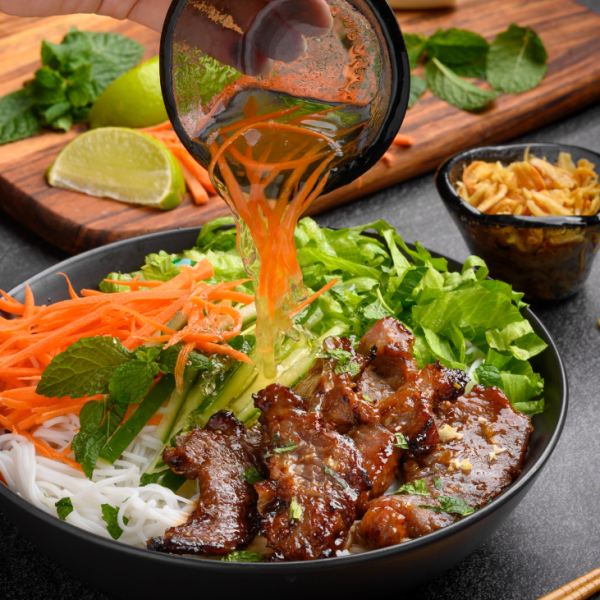 Bun Thit Nuong with grilled pork and fresh vegetables.