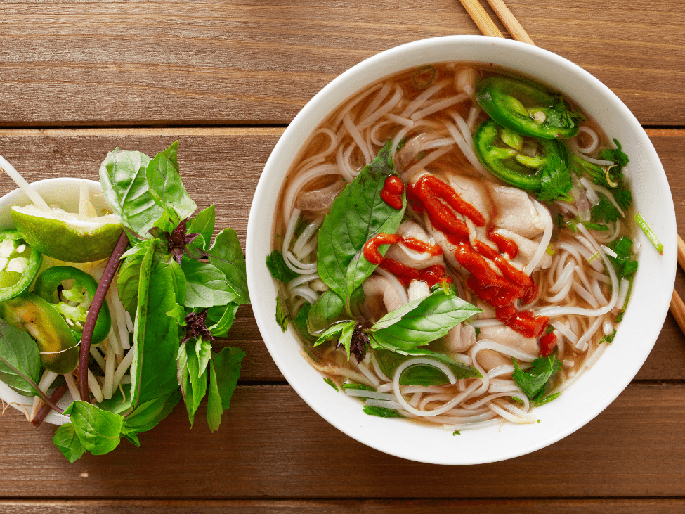 A steaming bowl of pho ca being prepared at a floating market in Can Tho.