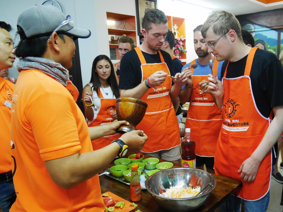 Tourists on a Vespa tour exploring Thailand's culinary delights