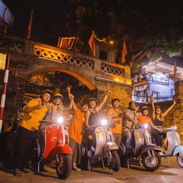 Travelers exploring Hanoi's vibrant night during the Hanoi After Dark tour.