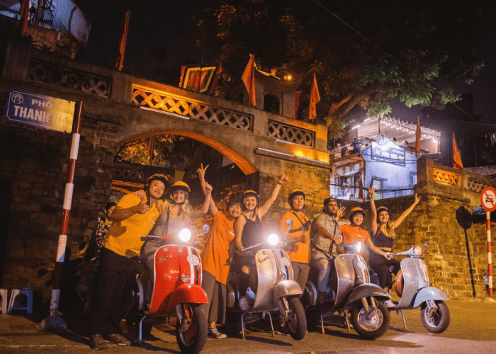 Travelers exploring Hanoi's vibrant night during the Hanoi After Dark tour.