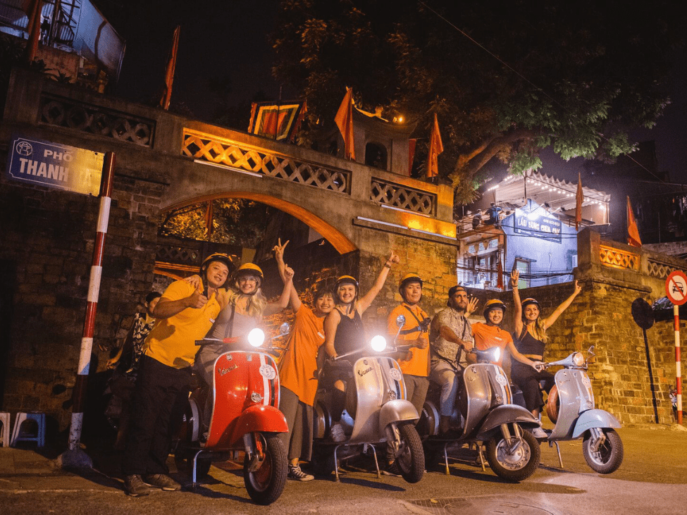 Travelers exploring Hanoi's vibrant night during the Hanoi After Dark tour.