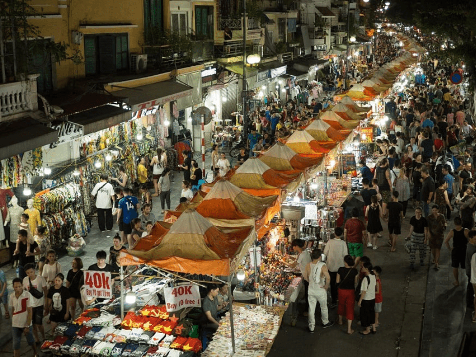 Bustling night market in Hanoi filled with colorful food stalls