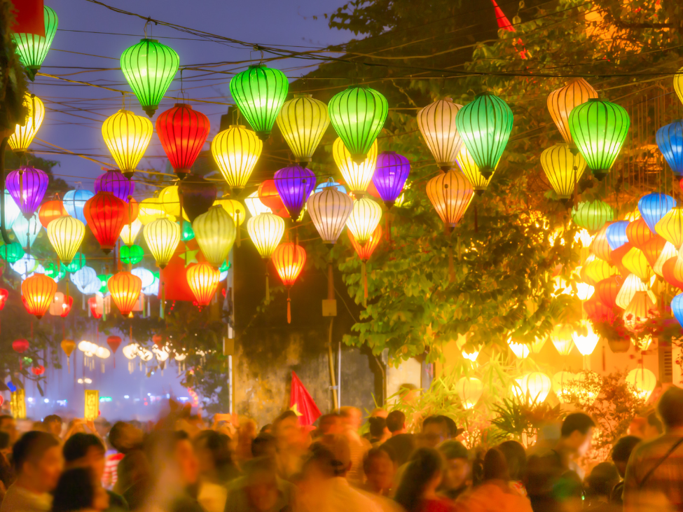 Vibrant lanterns floating on the Thu Bon River during the Hoi An Lantern Festival.