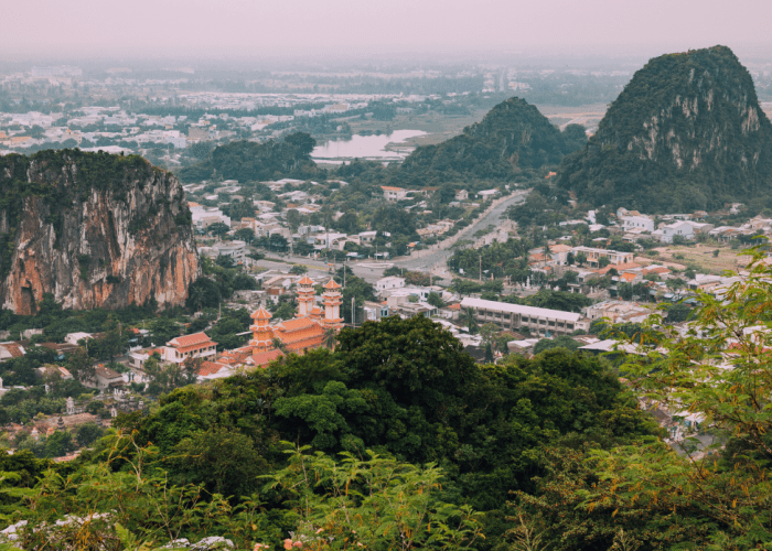 Panoramic view from the peak of Thuy Son Mountain, showcasing Da Nang's coastline and cityscape.