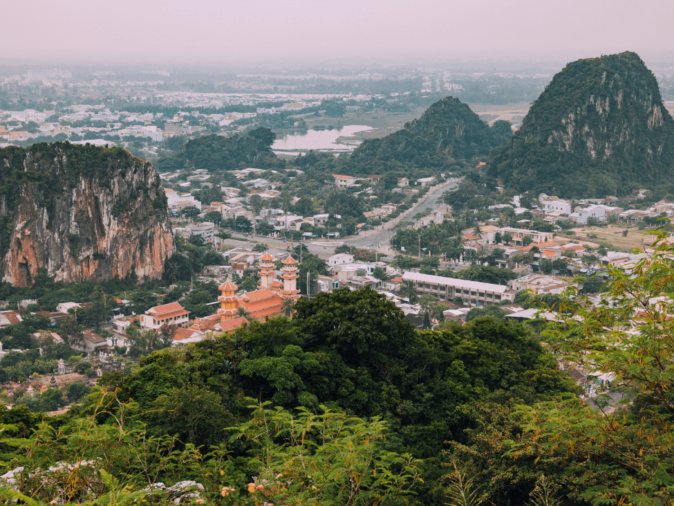 The entrance gate to the Marble Mountains in Da Nang, framed by lush greenery and traditional architecture.