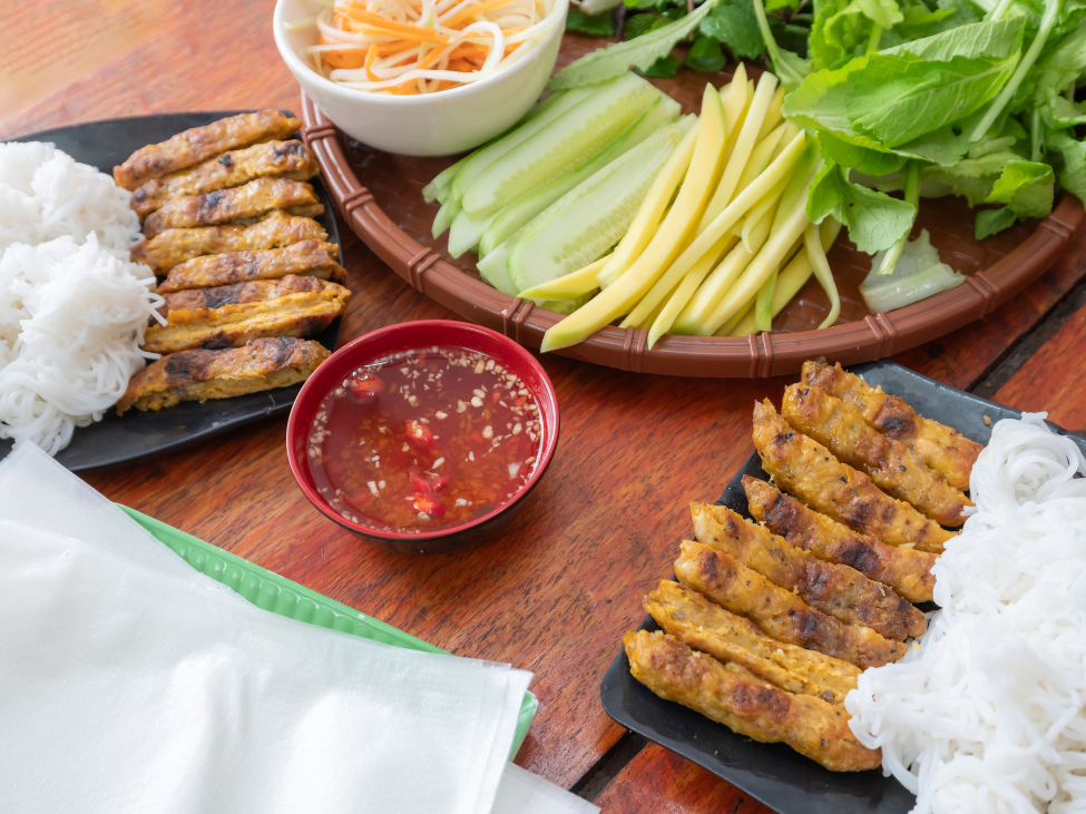 Nem Lui pork rolls skewered on lemongrass.