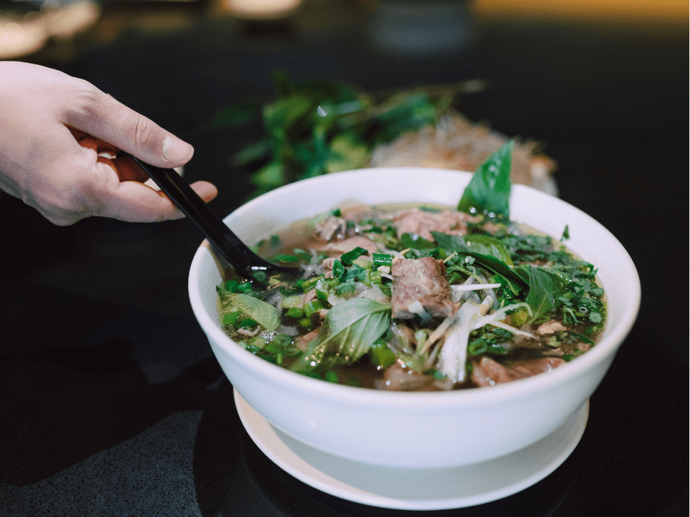 Best pho in Hanoi, a steaming bowl of aromatic broth and fresh herbs