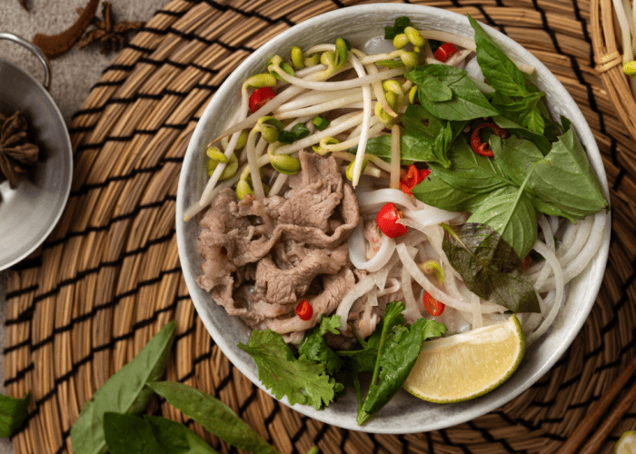 A steaming bowl of pho Vietnamese soup at Pho Thin Tokyo, showcasing Hanoi-style broth and fresh herbs.