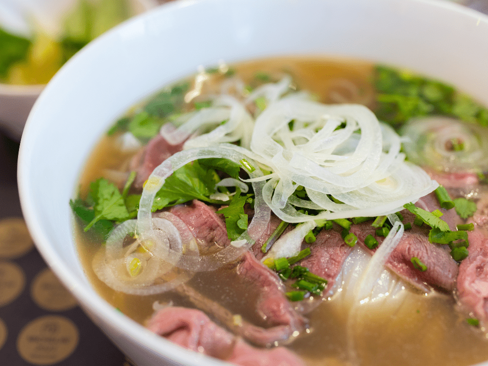 A night-time bowl of pho noodle soup at Pho Trang Tien, perfect for late-night cravings in Hanoi.