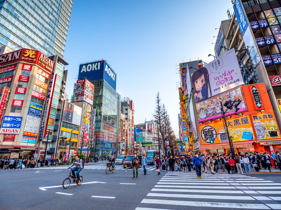 Bustling streets of Tokyo with a Vietnamese pho restaurant, showcasing the blend of Japanese and Vietnamese culture.