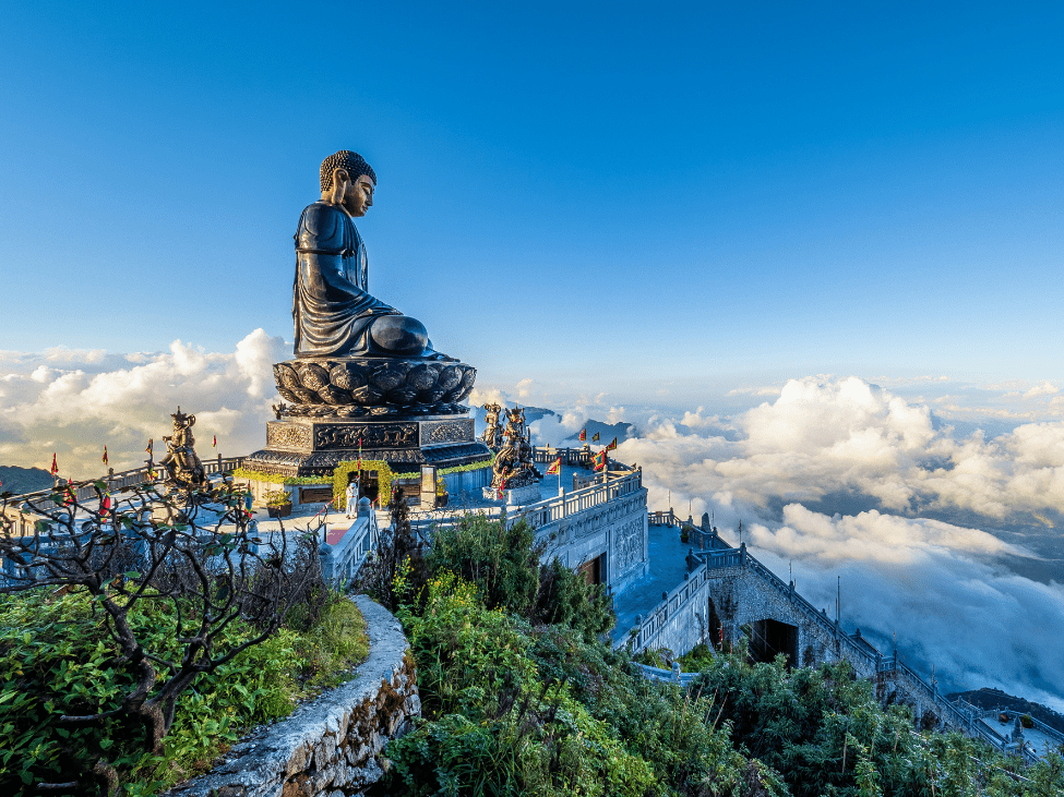 Tourist enjoying the view from Fansipan peak in Vietnam.