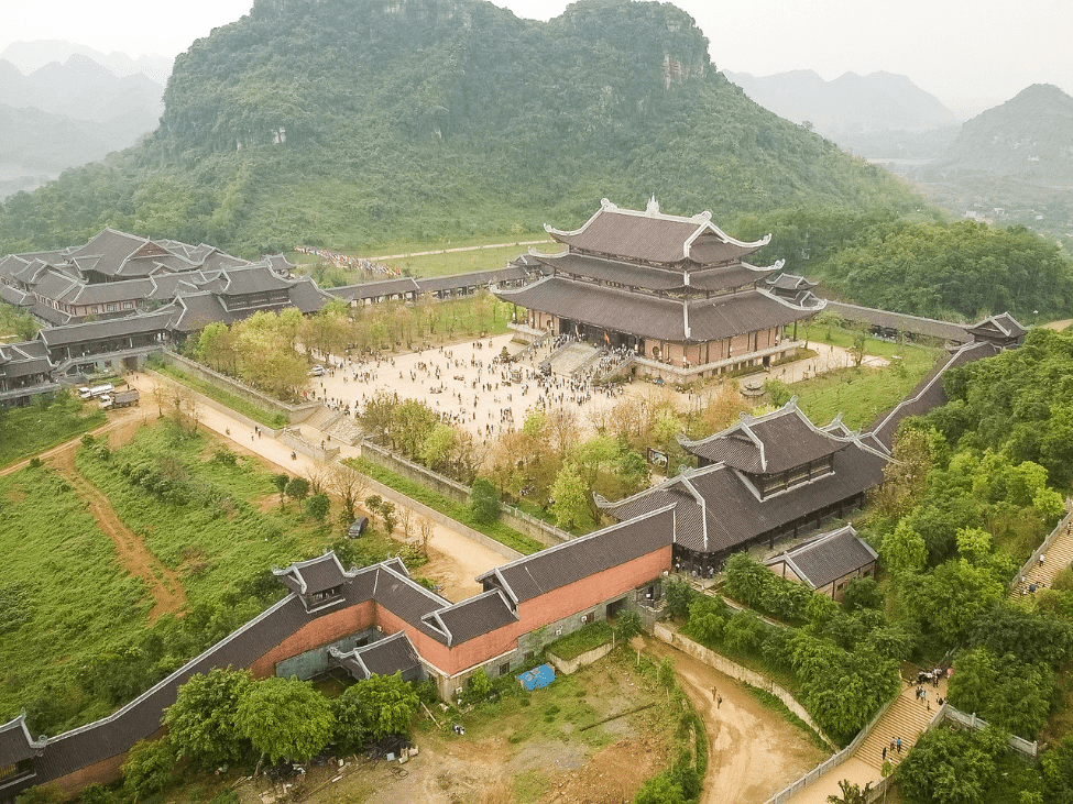 The expansive Bai Dinh Pagoda complex in Ninh Binh, surrounded by green hills and lakes.