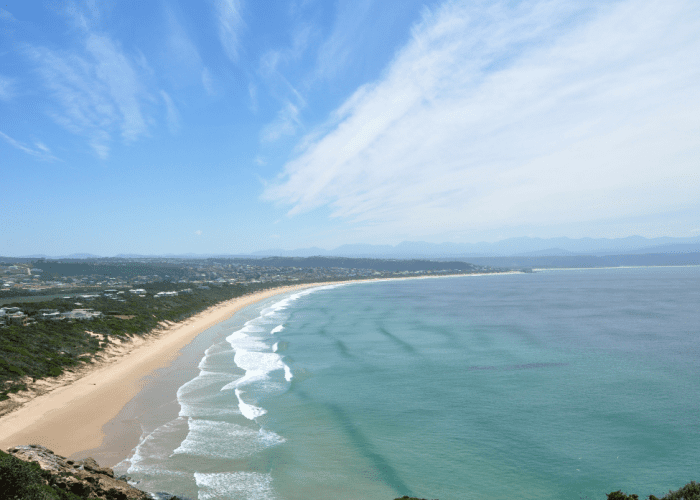 Crescent-shaped shoreline and clear waters of Bai Khem Beach.