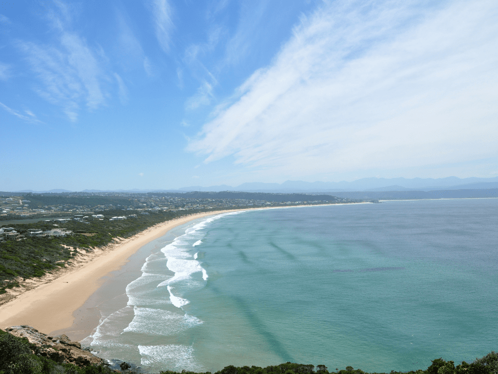 Crescent-shaped shoreline and clear waters of Bai Khem Beach.